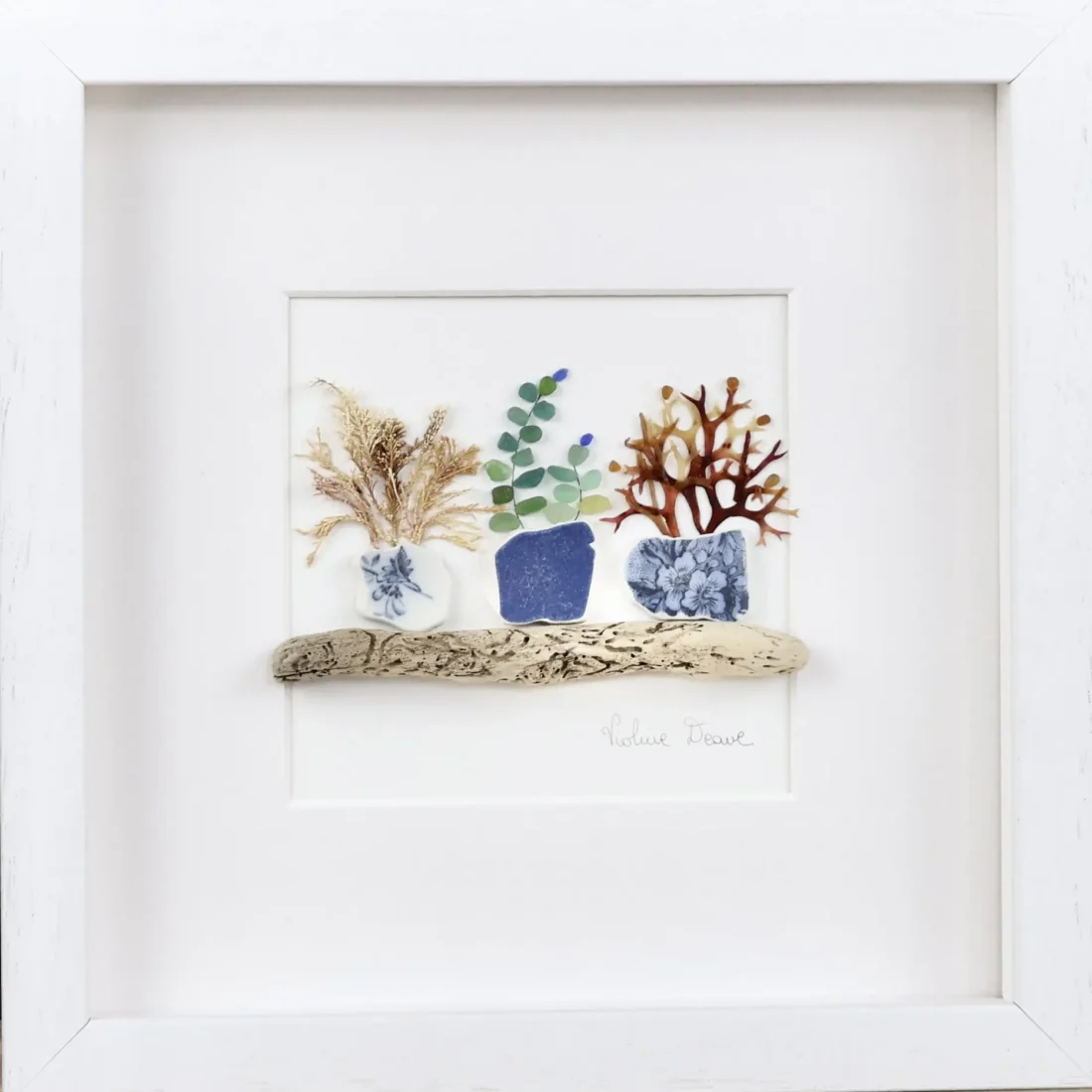 Framed coastal artwork in a calm interior