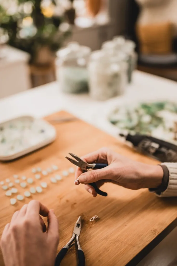 Violine shaping jewellery by hand at her Greystones worktable