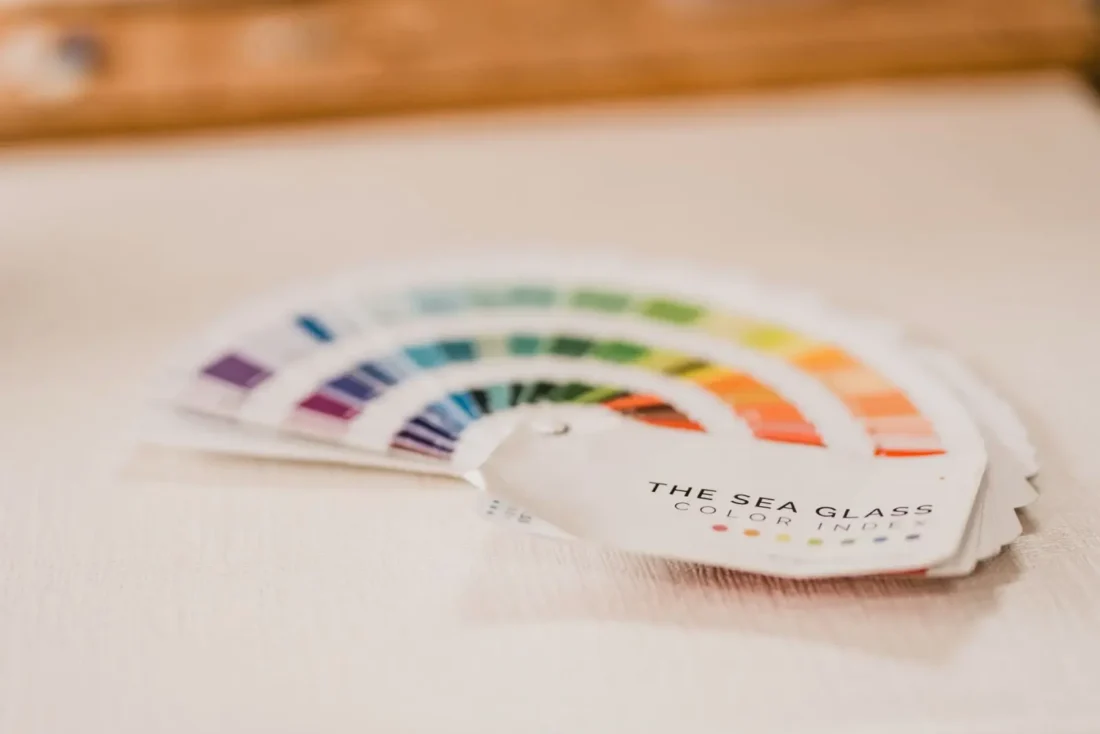 A sea glass colour reference fan showing shades from violet to amber